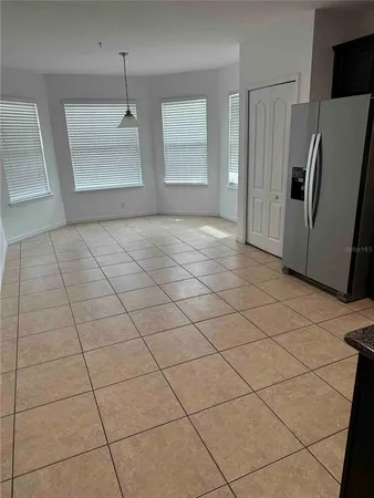 a view of a refrigerator and window in a kitchen
