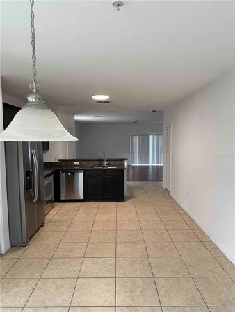 a large kitchen with kitchen island a counter top space and cabinets