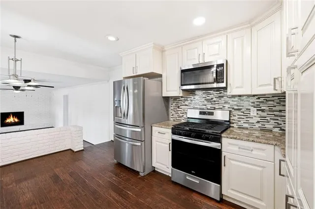 a kitchen with a refrigerator stove and microwave