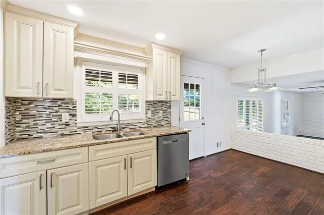 a kitchen with a sink stove and cabinets