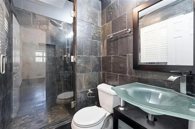 a bathroom with a sink toilet and shower
