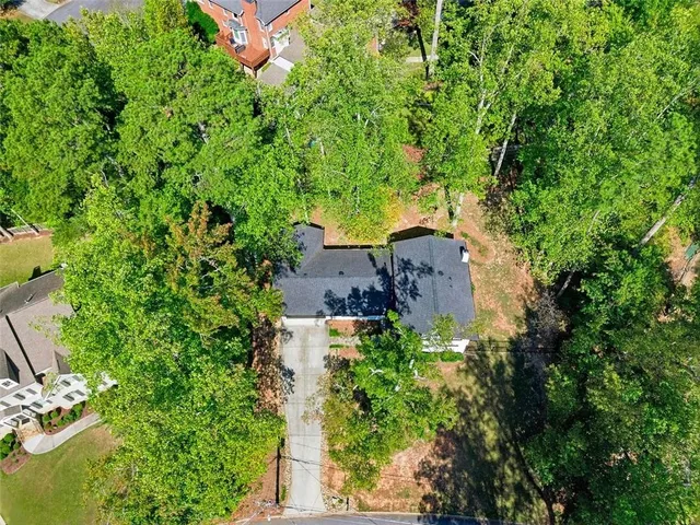 an aerial view of a house with a yard