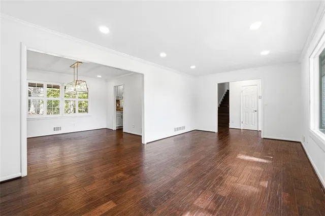 an empty room with wooden floor and a window