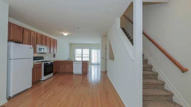 a kitchen with a refrigerator and a stove top oven