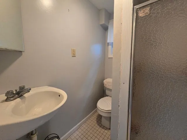 a bathroom with a sink toilet and a mirror