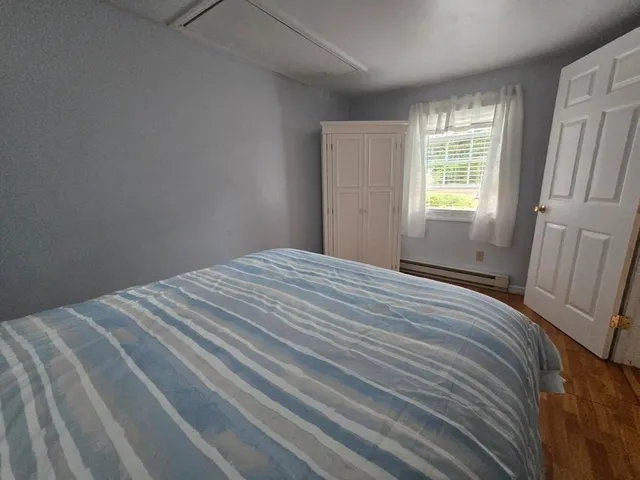 a bedroom with a bed and a window