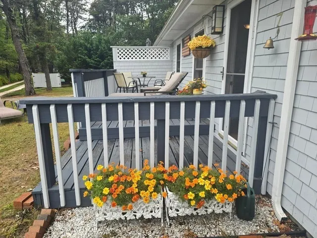 a view of a wooden bench next to a yard