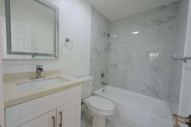 a bathroom with a sink a toilet and bathtub