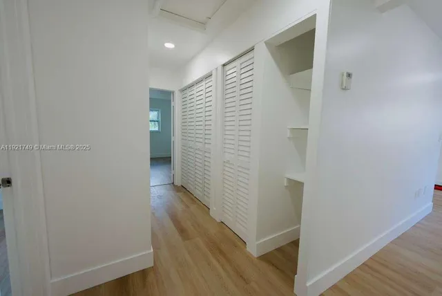a view of hallway with wooden floor