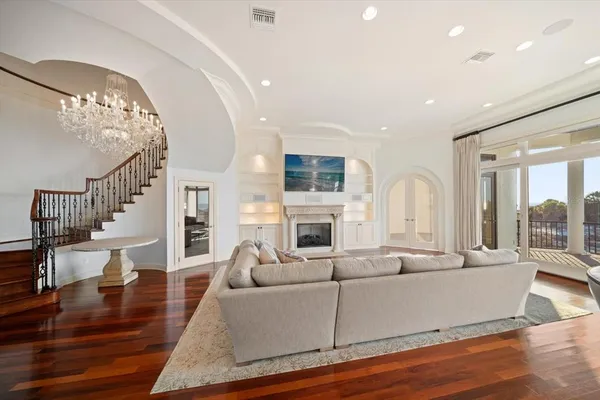 a view of a livingroom with wooden floor and a large window