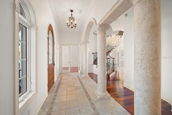 a bedroom with a bed a couch and a large window