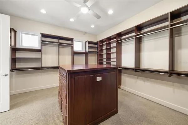 a view of a big room with closet and windows