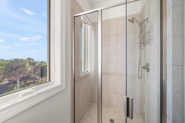 a front view of a house with a yard and ocean view