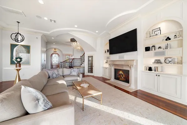 a living room with fireplace furniture and a wooden floor