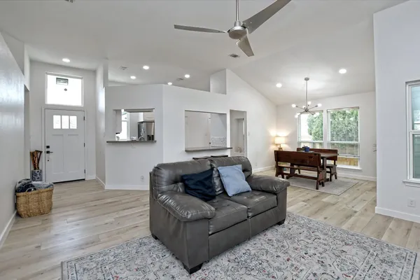 a living room with furniture and a wooden floor