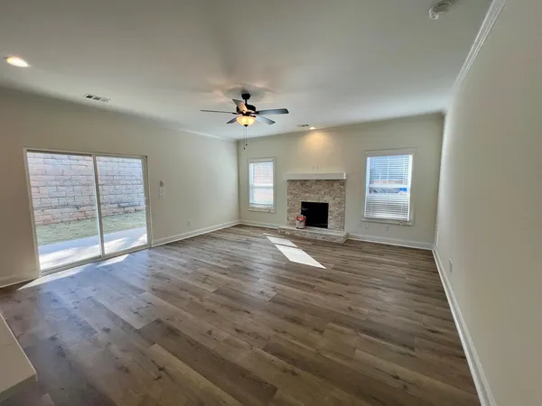 wooden floor in an empty room with a window