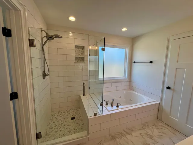 a bathroom with a bathtub and shower