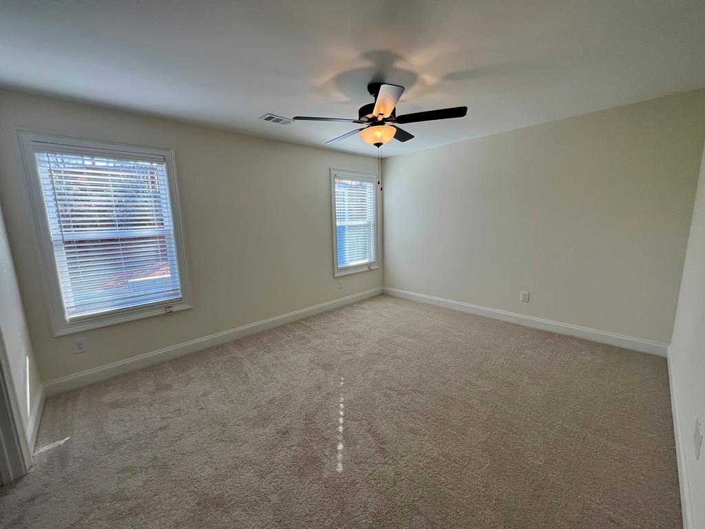 7015 Spring Walk Drive Columbus, GA 31904 - Photo 20 of 28 an empty room with windows and fan
