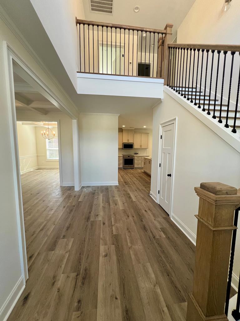 7015 Spring Walk Drive Columbus, GA 31904 - Photo 5 of 28 a view of a hallway with wooden floor and staircase