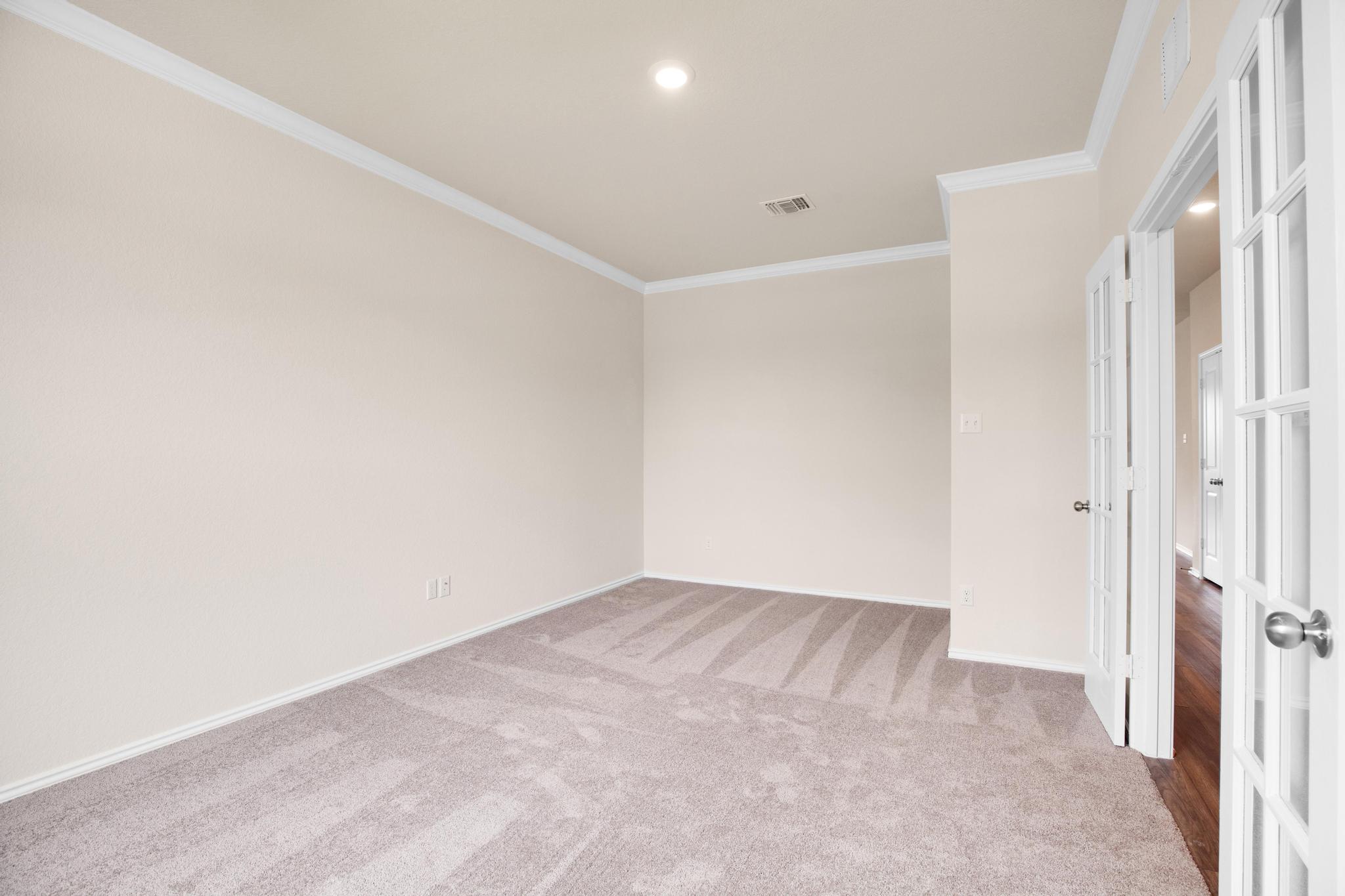 200 Janice Road Taylor, TX 76574 - Photo 17 of 25 French doors open into a versatile space featuring crown molding and recessed lighting.