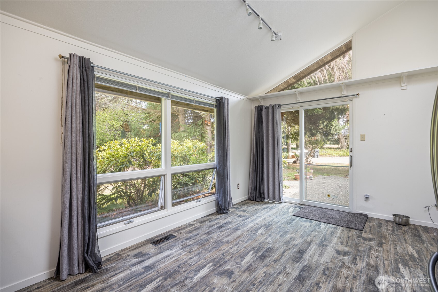 1175 Cameron Road Sequim, WA 98382 - Photo 23 of 39 a view of an empty room with wooden floor and a window