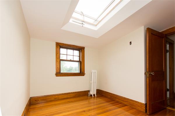281 Glen Road Weston, MA 02493 - Photo 15 of 18 a view of an empty room with wooden floor and a window