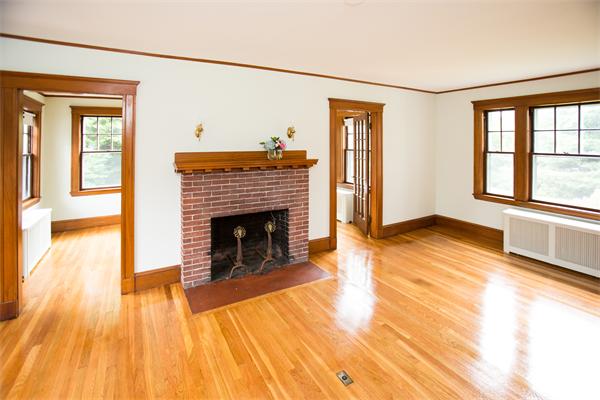 281 Glen Road Weston, MA 02493 - Photo 6 of 18 a view of a livingroom with wooden floor and a fireplace