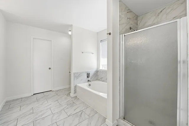 a bathroom with a bathtub and a shower