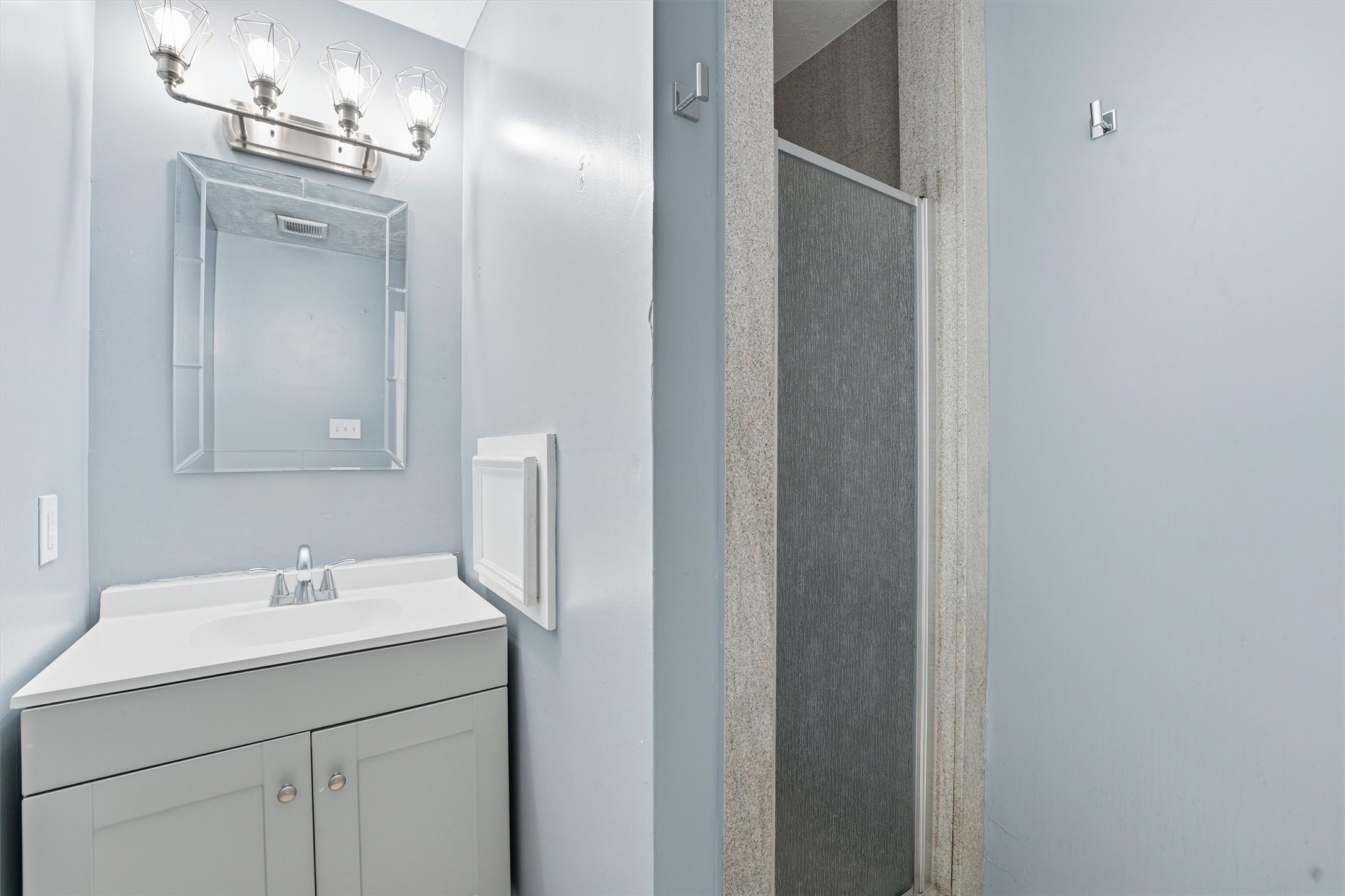 18385 Ten Oaks Court Porter, TX 77365 - Photo 25 of 31 a bathroom with a sink and a mirror