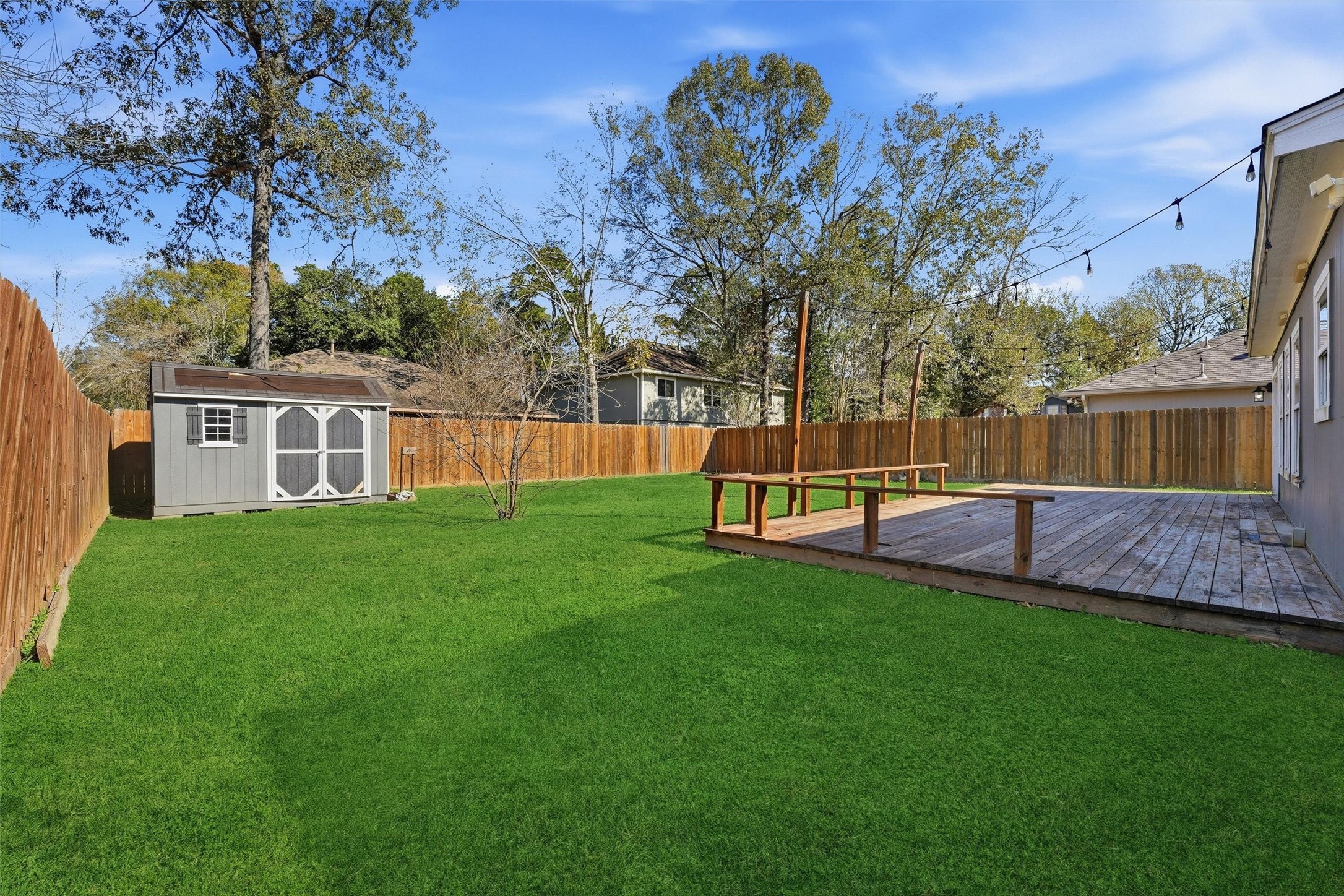 18385 Ten Oaks Court Porter, TX 77365 - Photo 27 of 31 a view of a backyard with a small cabin