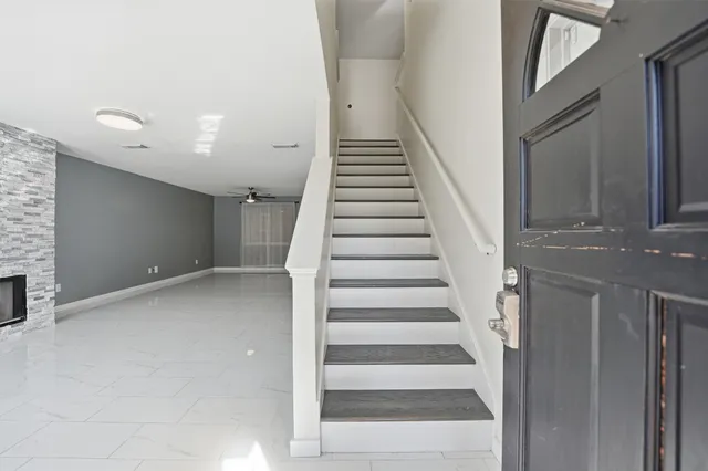a view of staircase with white walls and windows