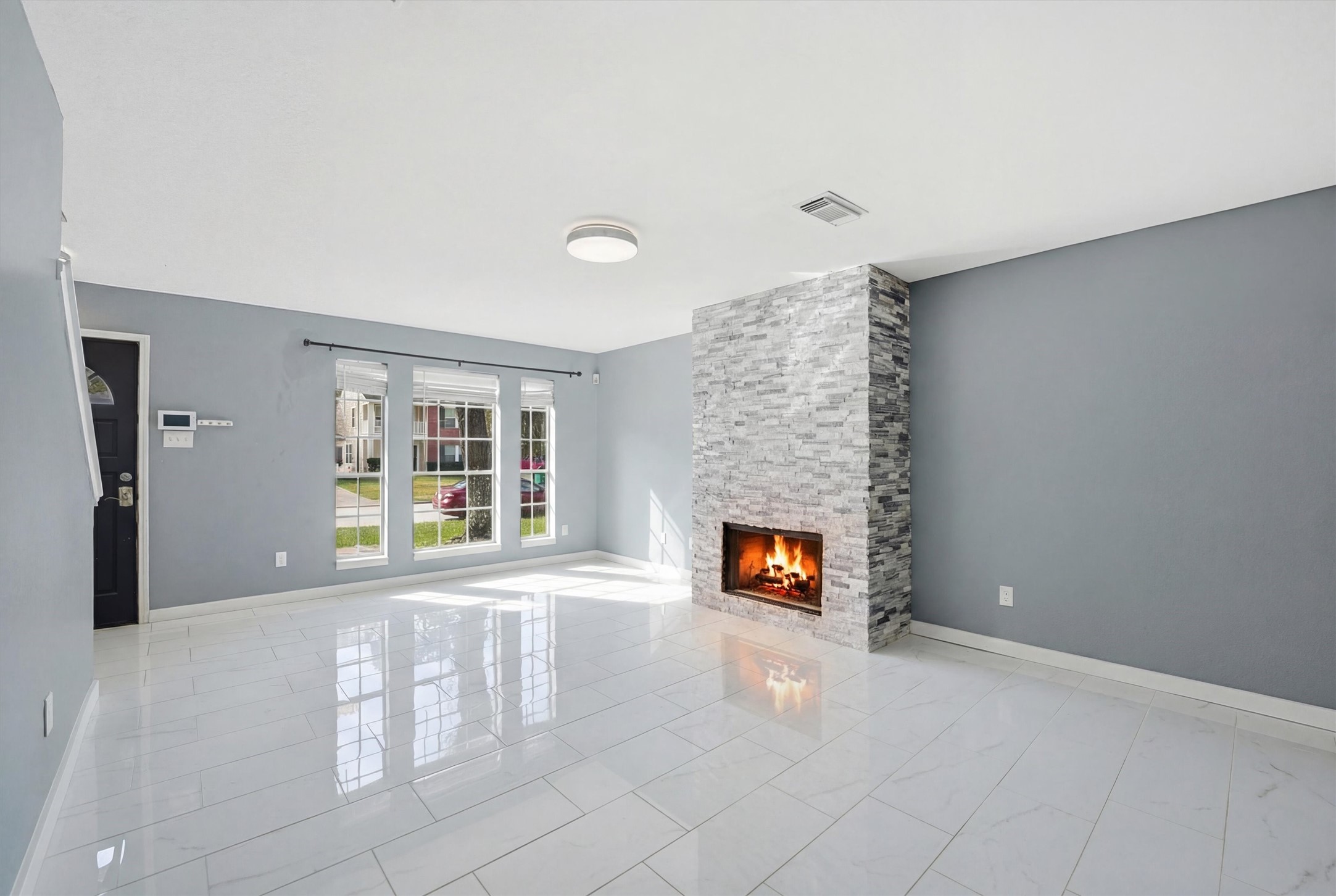 18385 Ten Oaks Court Porter, TX 77365 - Photo 5 of 31 a view of an empty room with a fireplace and a window