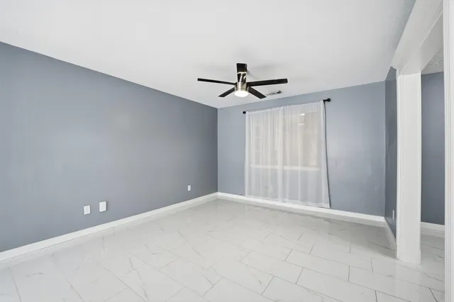 a view of room with window and ceiling fan