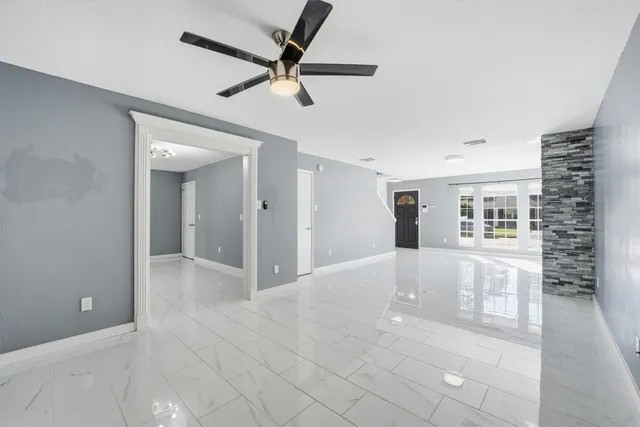 a view of a livingroom with a ceiling fan and window