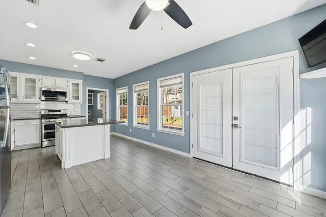 a view of kitchen with microwave and refrigerator