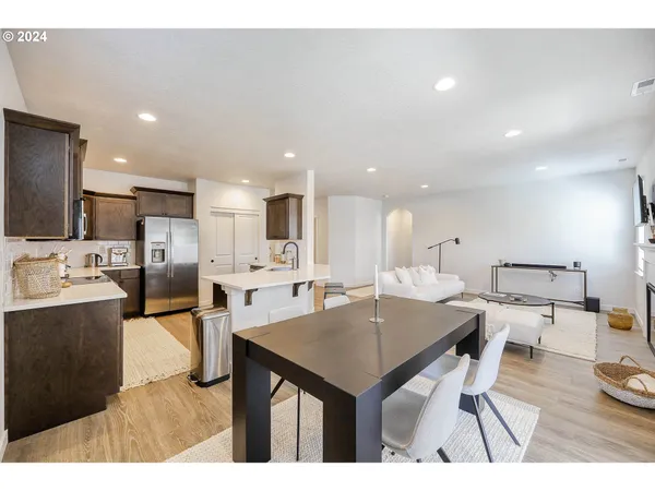 a kitchen with stainless steel appliances kitchen island granite countertop a sink and cabinets