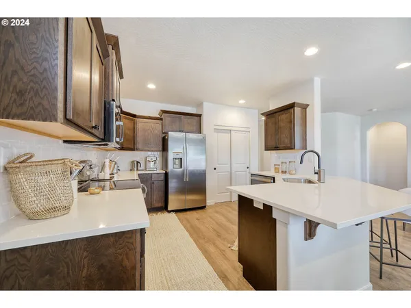 a kitchen with kitchen island a sink appliances and cabinets