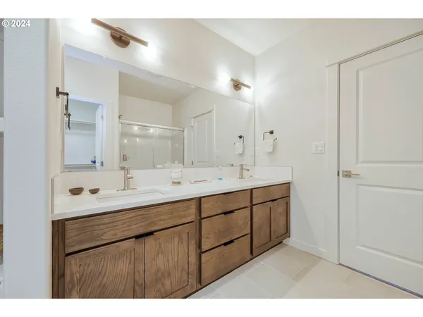 a bathroom with a double vanity sink and mirror