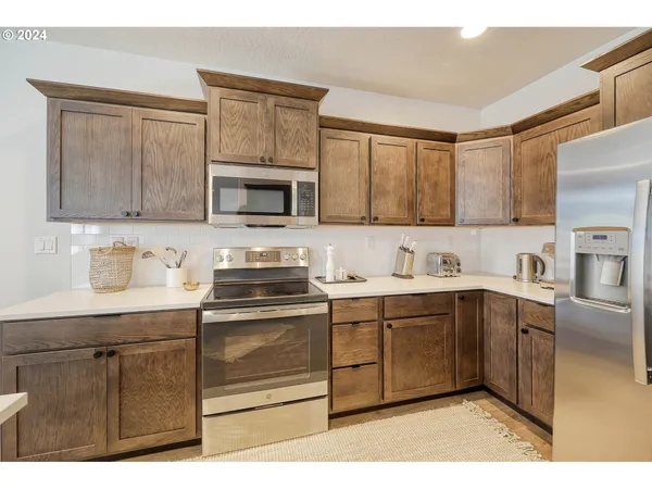 a kitchen with stainless steel appliances granite countertop a sink stove and microwave