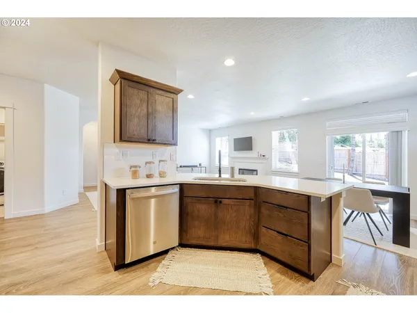 a large kitchen with kitchen island a sink a stove a dining table and chairs