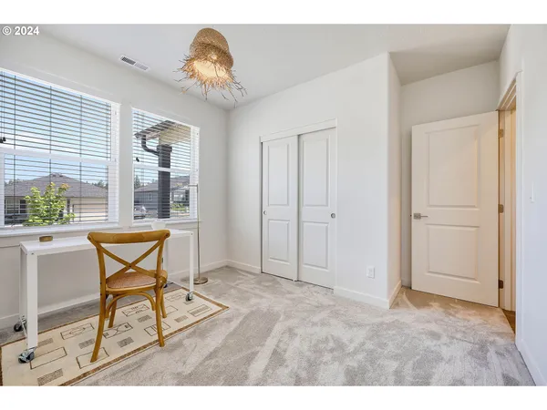 a workspace with chandelier fan and wooden floor
