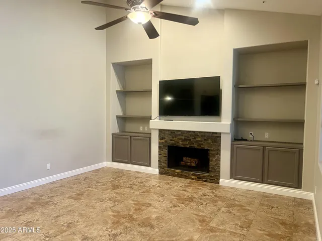 a living room with a fireplace and a flat screen tv