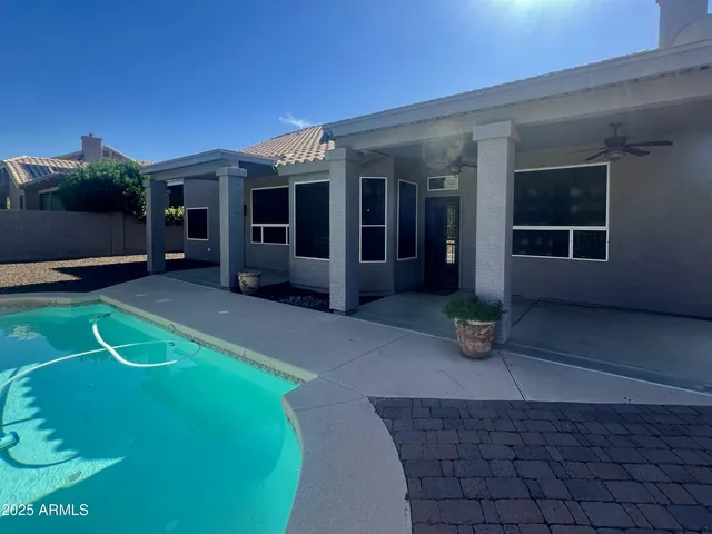 a view of a house with a yard and sitting area