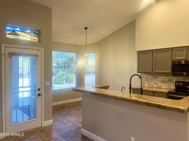 a view of a kitchen with a sink and a window