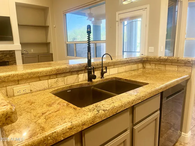 a view of a kitchen counter top a sink and dishwasher