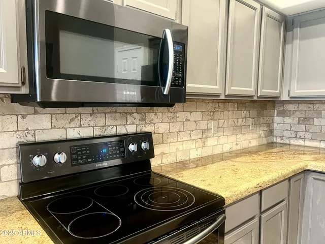 a kitchen with a stove and a microwave