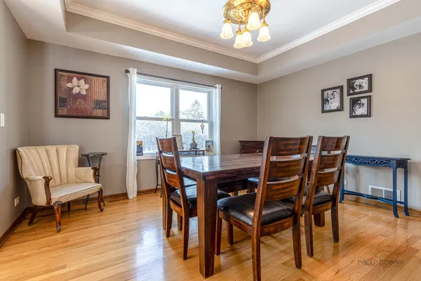 a view of a dining room with furniture window and wooden floor