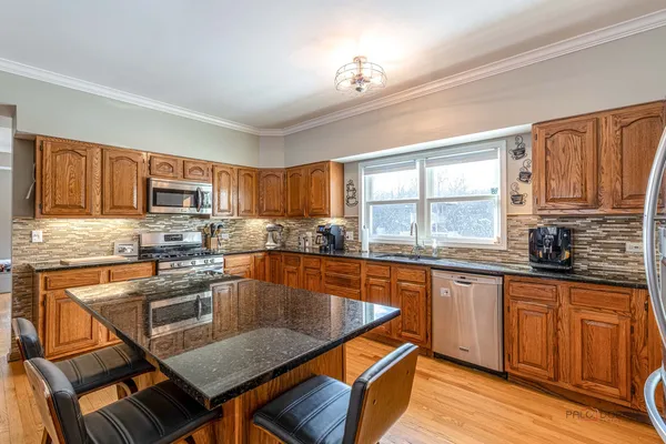 a living room with furniture and a view of kitchen