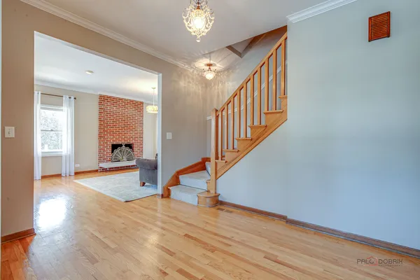 a view of a hallway view with wooden floor and staircase