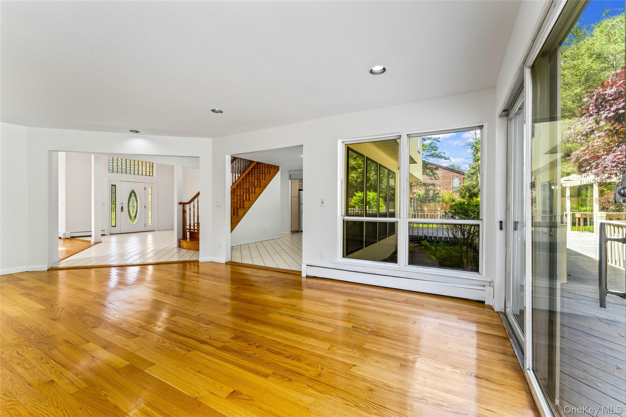 126 Bagatelle Road Melville, NY 11747 - Photo 17 of 50 a view of an empty room with wooden floor and a window